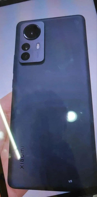 Xiaomi 12 Pro in black and preinstalled with MIUI 13 lit up in live photos